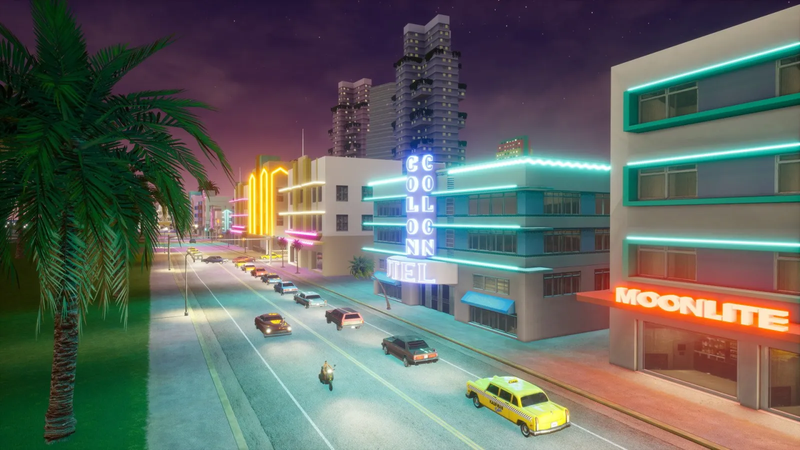 GTA Vice City Definitive Edition’da gece Vice City sahil yolu boyunca neon oteller