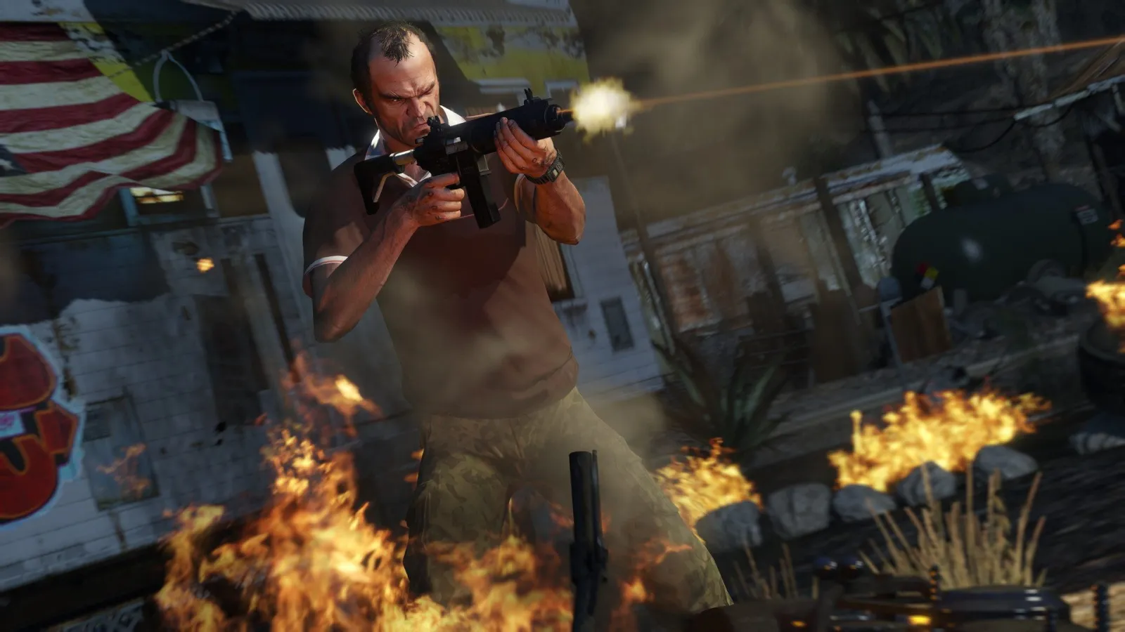Trevor strzela z pistoletu maszynowego wśród płomieni w GTA 5